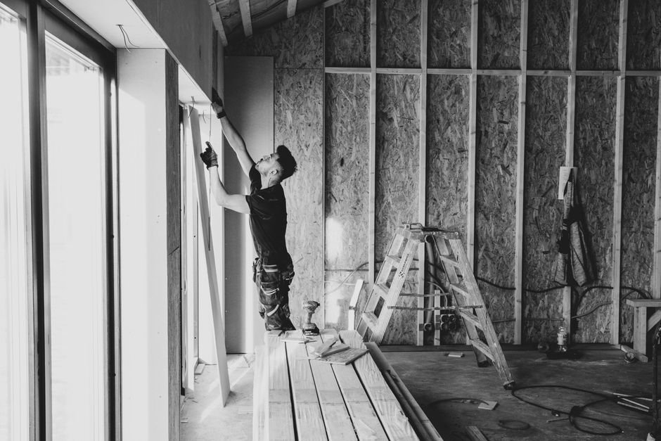 Professional contractor carefully installing a new double hung window