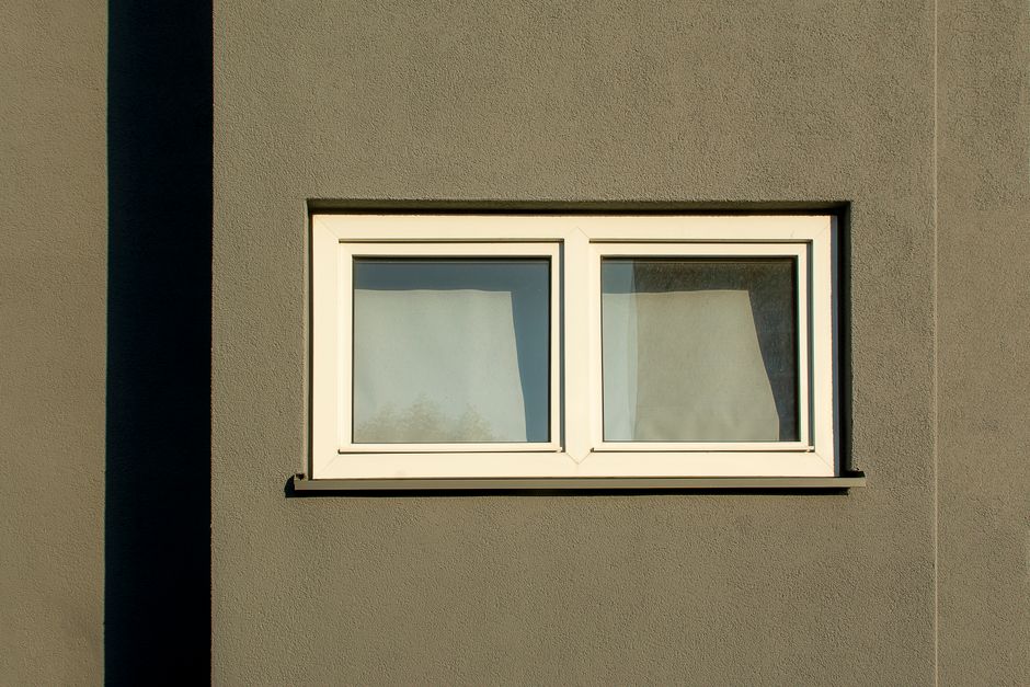 Clean white replacement window frame installed in a modern home